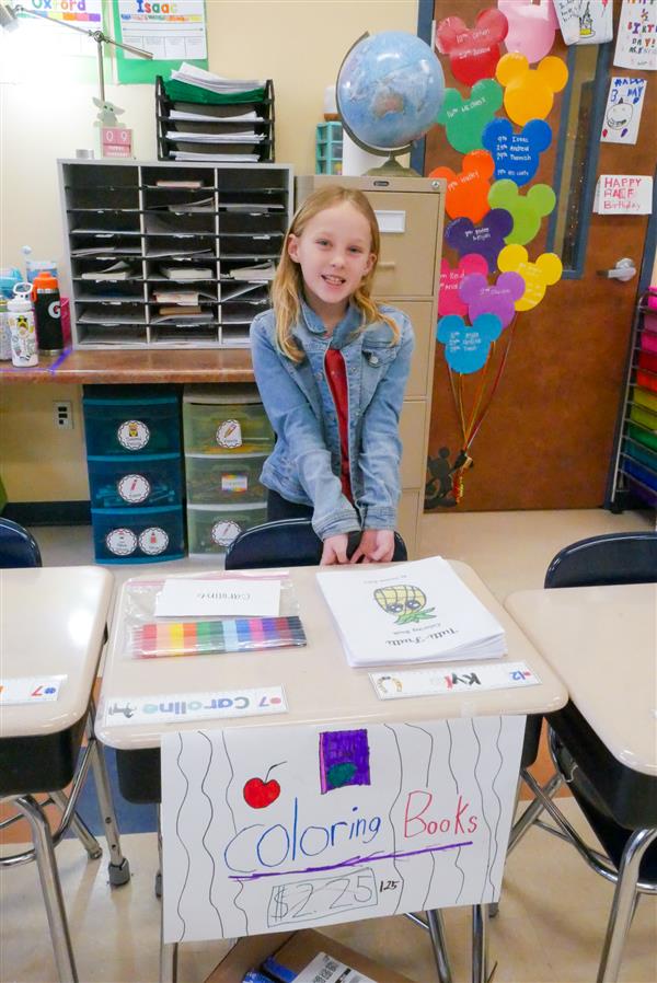 girl selling coloring books
